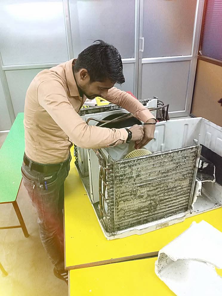 Technician repairing appliance